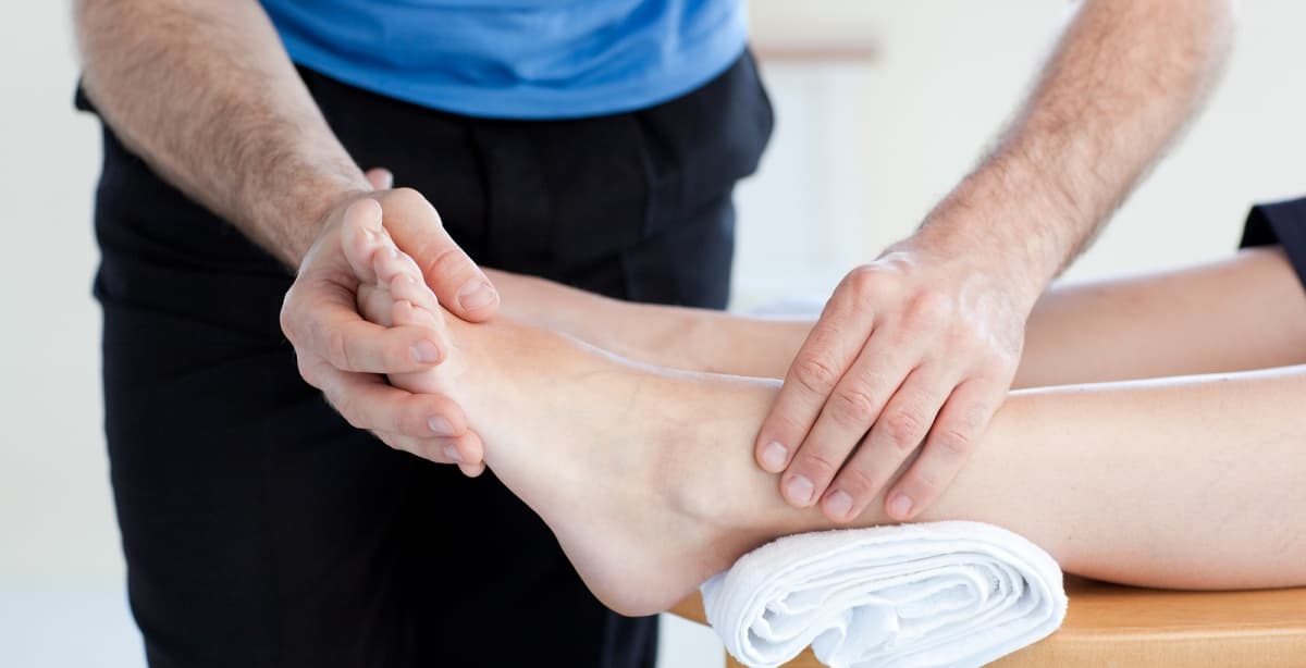 Physical therapist supporting a patient's foot and ankle