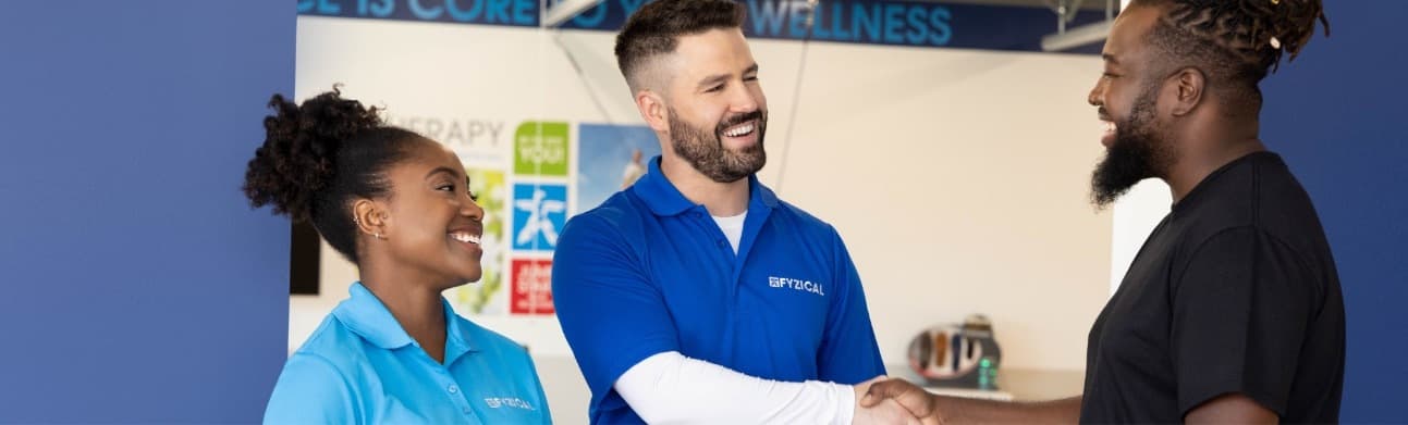 FYZICAL team member welcoming a patient